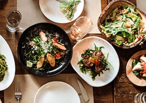 Overhead view of assorted plates of fresh California cuisine at a restaurant in El Segundo.