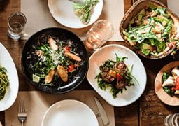 Overhead view of assorted plates of fresh California cuisine at a restaurant in El Segundo.